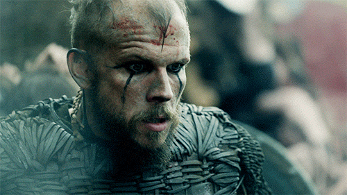 A GIF of Floki from Vikings guesturing in front of his face. He's bloody and looks startled.