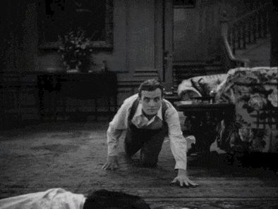 Renfield from Dracula slowly crawling towards an unconscious woman.